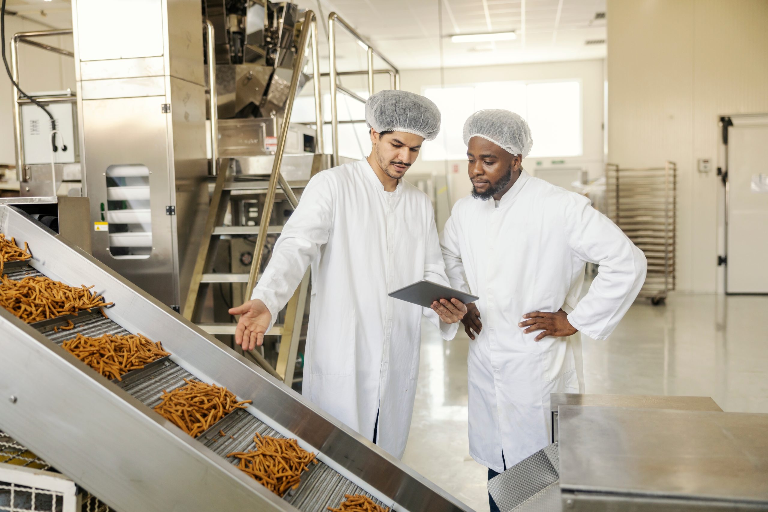 Interracial,supervisor,with,tablet,doing,quality,control,check,of,food